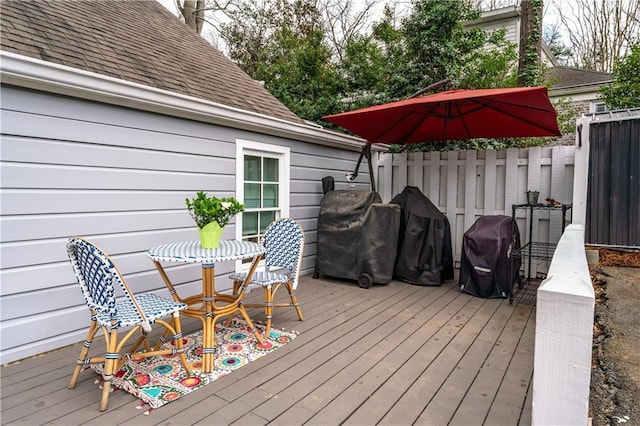 deck with fence and area for grilling