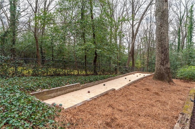 view of yard with fence and a view of trees