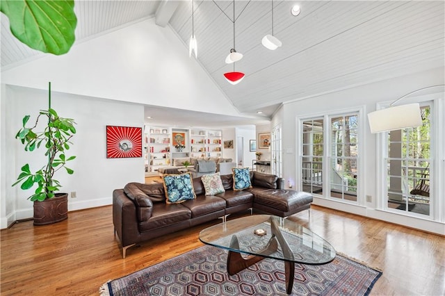 living area featuring baseboards, wood ceiling, high vaulted ceiling, wood finished floors, and beamed ceiling