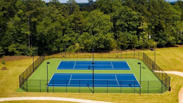 view of sport court featuring a yard