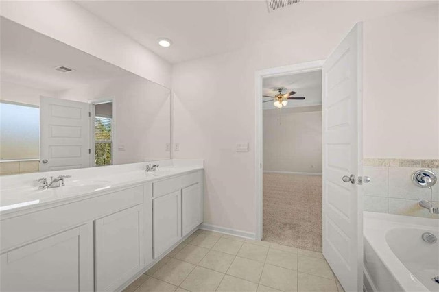 bathroom with ceiling fan, tile patterned floors, a bathtub, and vanity