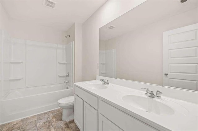 full bathroom featuring toilet, vanity, and  shower combination