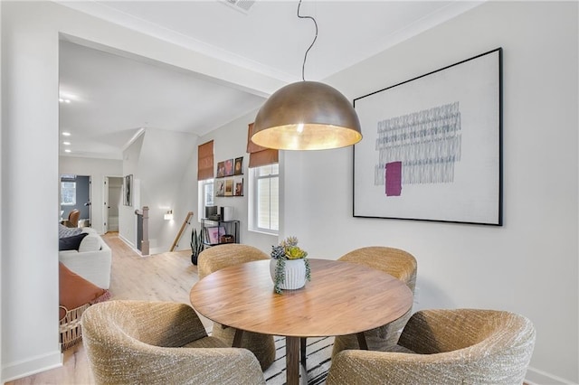 dining space featuring plenty of natural light, baseboards, and wood finished floors