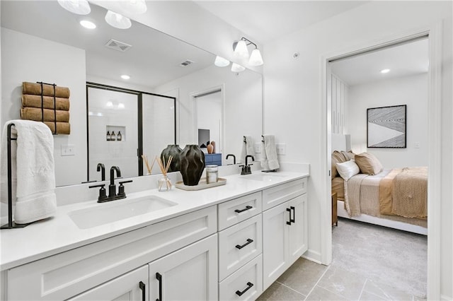 full bath with double vanity, a stall shower, visible vents, and a sink