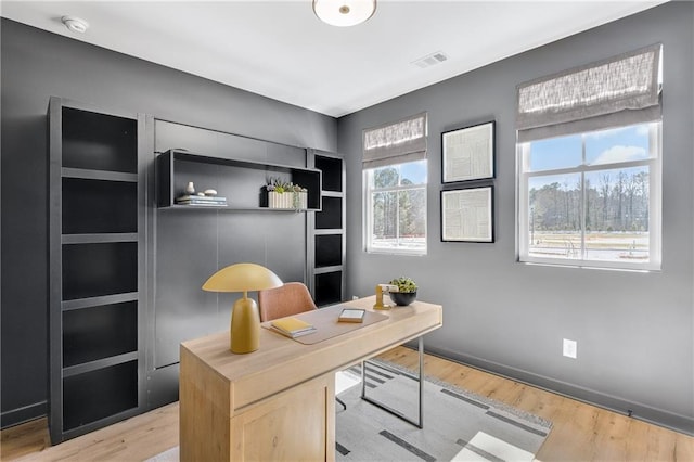 office featuring light wood-style flooring and visible vents