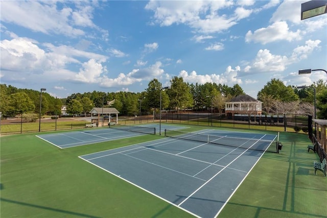 view of tennis court featuring fence