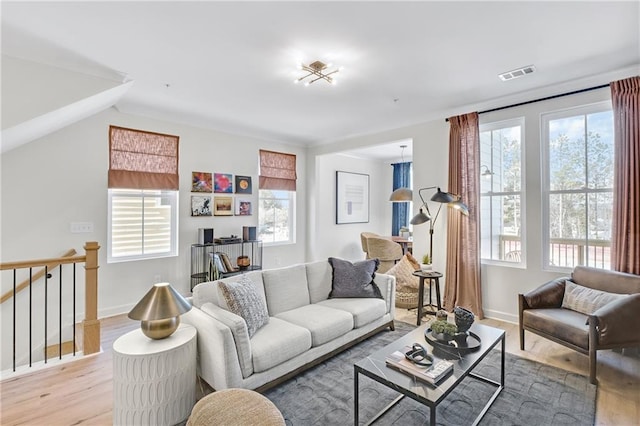 living room with visible vents, a healthy amount of sunlight, and light wood finished floors