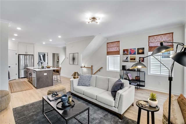 living room with light wood-style flooring, recessed lighting, and baseboards