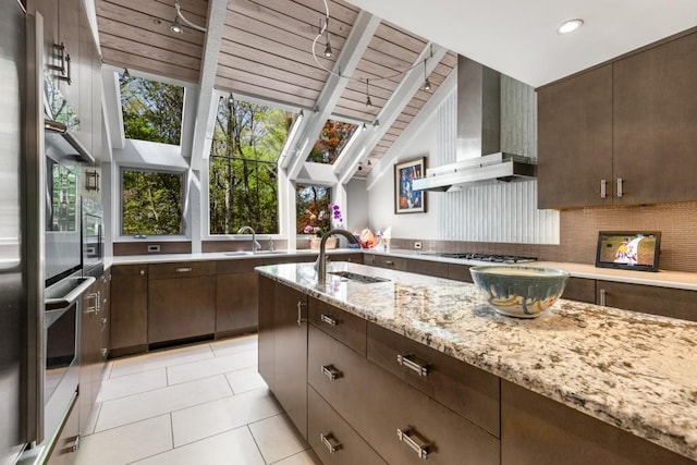 6525 Old Riverside Dr NW, Sandy Springs, GA 30328 - kitchen featuring track lighting, a sink, decorative backsplash, and light stone countertops