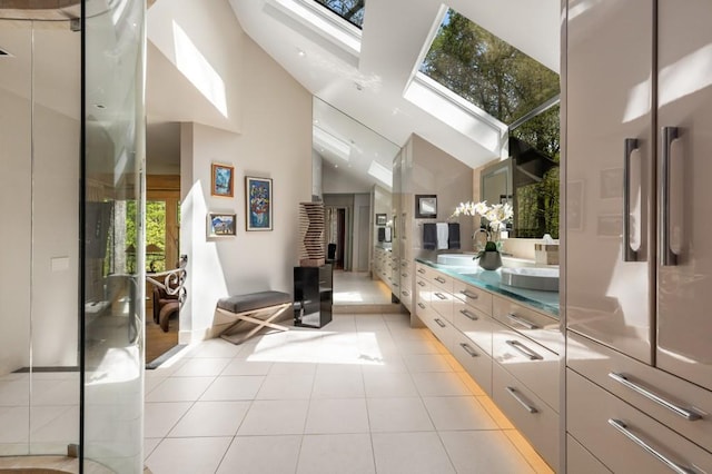 6525 Old Riverside Dr NW, Sandy Springs, GA 30328 - bathroom with a skylight, tile patterned floors, double vanity, a sink, and high vaulted ceiling