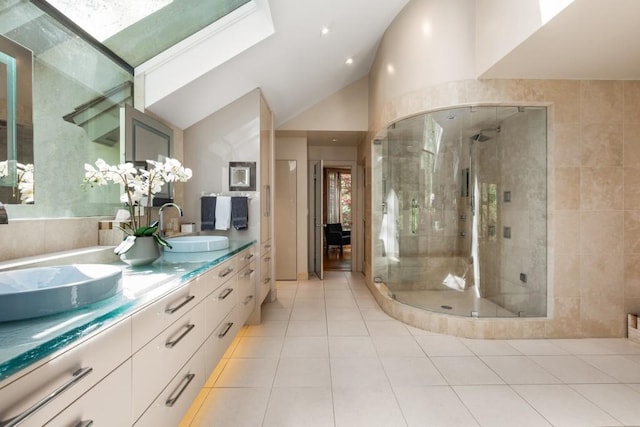 6525 Old Riverside Dr NW, Sandy Springs, GA 30328 - full bathroom featuring vaulted ceiling with skylight, tile patterned flooring, a shower stall, double vanity, and a sink