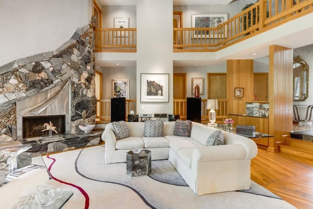 6525 Old Riverside Dr NW, Sandy Springs, GA 30328 - living area featuring wood finished floors, a stone fireplace, and a towering ceiling