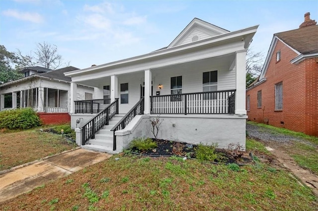 greek revival house with covered porch and a front yard