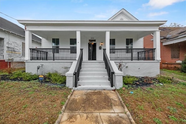 view of front of home featuring covered porch and a front yard