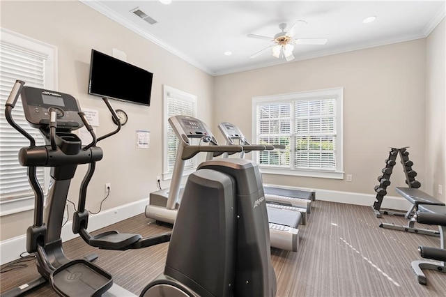 workout room featuring carpet flooring, a ceiling fan, baseboards, visible vents, and ornamental molding