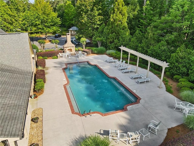 community pool featuring a pergola and a patio area