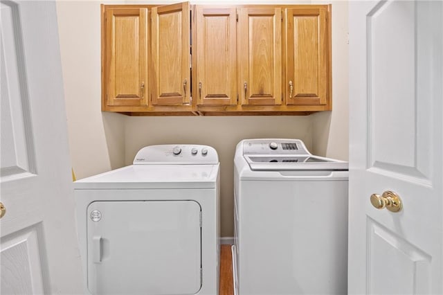 laundry area with cabinet space and independent washer and dryer