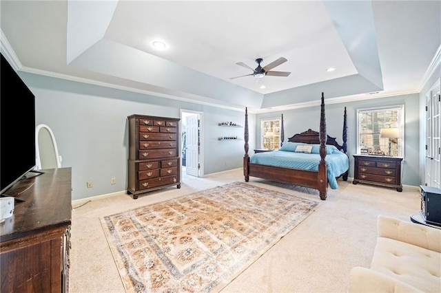 bedroom featuring crown molding, baseboards, light carpet, a raised ceiling, and a ceiling fan