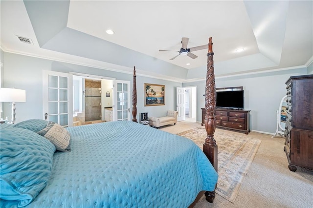 bedroom with visible vents, a tray ceiling, french doors, carpet floors, and crown molding