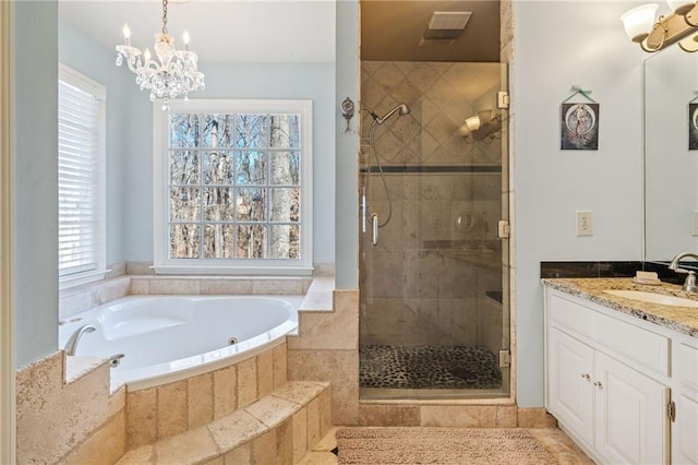 bathroom with a bath, a notable chandelier, a shower stall, and vanity