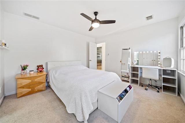 carpeted bedroom featuring a ceiling fan and visible vents