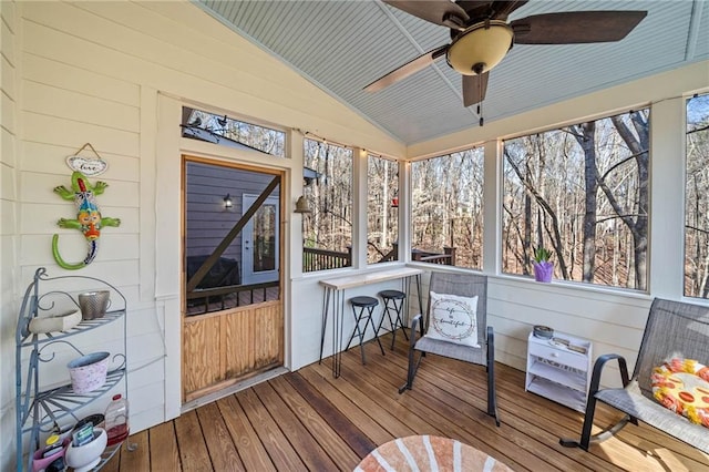 sunroom / solarium featuring vaulted ceiling and a ceiling fan