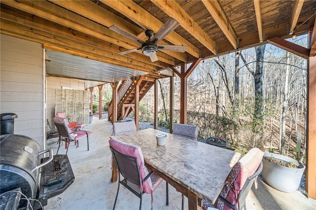 view of patio / terrace with stairway, outdoor dining area, and a ceiling fan