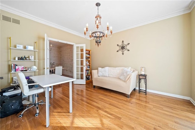 office space featuring visible vents, baseboards, light wood-style floors, crown molding, and a notable chandelier