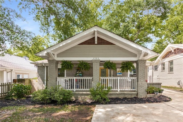 2486 Memorial Dr SE, Atlanta, GA 30317 - view of front of property with a porch, brick siding, and fence