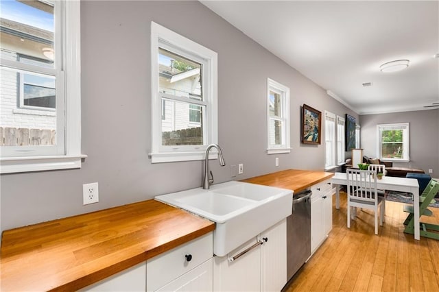 2486 Memorial Dr SE, Atlanta, GA 30317 - kitchen with wooden counters, white cabinetry, a sink, stainless steel dishwasher, and light wood-style floors