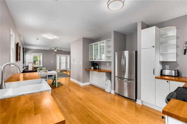 2486 Memorial Dr SE, Atlanta, GA 30317 - kitchen with freestanding refrigerator, open shelves, butcher block countertops, a sink, and light wood-type flooring