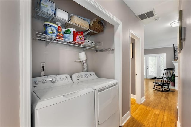 2486 Memorial Dr SE, Atlanta, GA 30317 - laundry room featuring washing machine and dryer, light wood-style flooring, baseboards, and ornamental molding