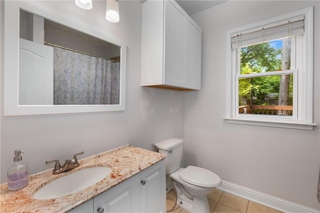 2486 Memorial Dr SE, Atlanta, GA 30317 - full bath featuring tile patterned floors, vanity, toilet, and baseboards