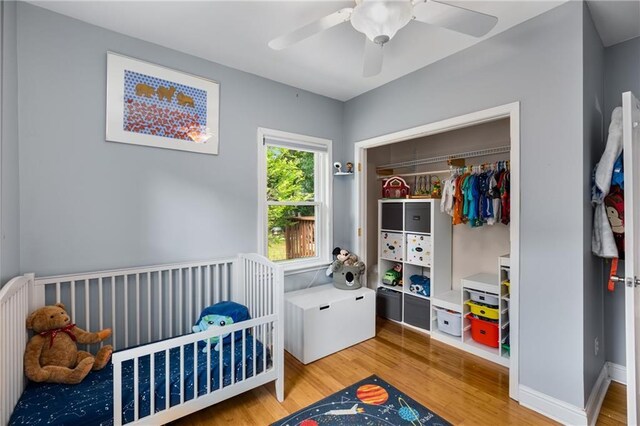 2486 Memorial Dr SE, Atlanta, GA 30317 - bedroom with light wood-type flooring, a ceiling fan, a closet, and a crib