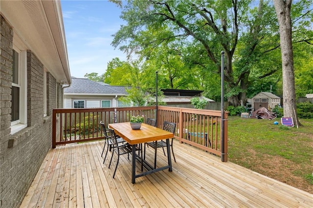 2486 Memorial Dr SE, Atlanta, GA 30317 - wooden deck with outdoor dining space, a shed, and an outbuilding