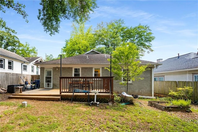2486 Memorial Dr SE, Atlanta, GA 30317 - rear view of property with a wooden deck, brick siding, and a vegetable garden