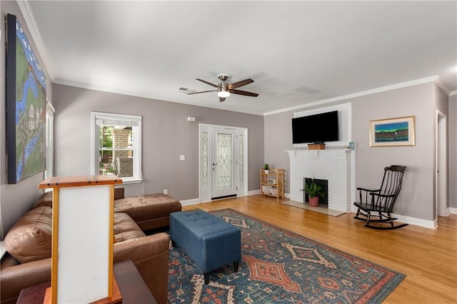 2486 Memorial Dr SE, Atlanta, GA 30317 - living room featuring ceiling fan, crown molding, wood finished floors, a brick fireplace, and baseboards