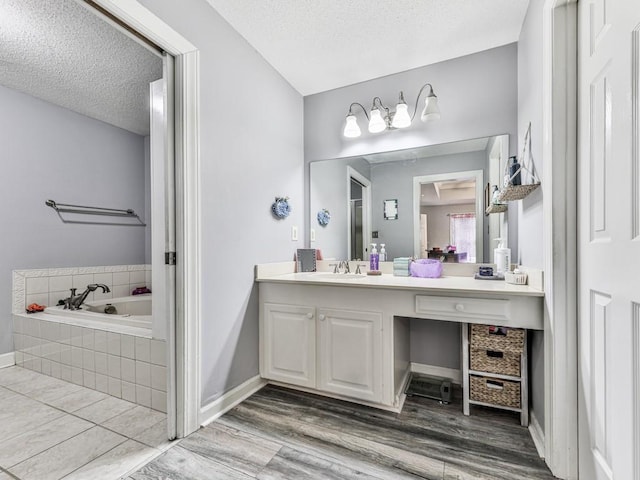 106 Warwick Way SE, Rome, GA 30161 - full bath with a garden tub, a textured ceiling, wood finished floors, and vanity