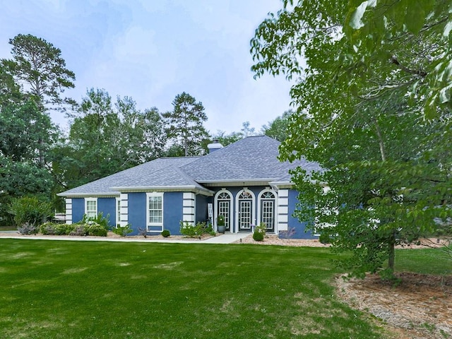 106 Warwick Way SE, Rome, GA 30161 - view of front of house with a front yard, a chimney, stucco siding, and roof with shingles