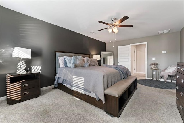 bedroom with ceiling fan and light carpet