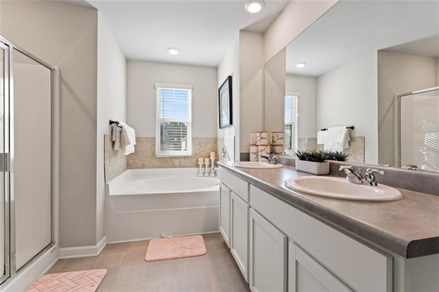 bathroom featuring vanity and independent shower and bath