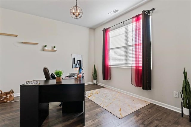 office space featuring dark hardwood / wood-style floors and an inviting chandelier