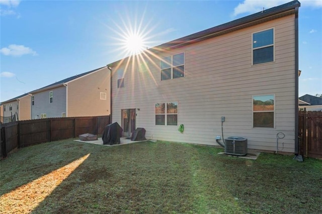 rear view of house featuring a yard, a patio, and central AC