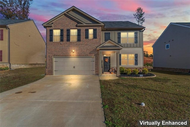 view of front of house with a yard and a garage