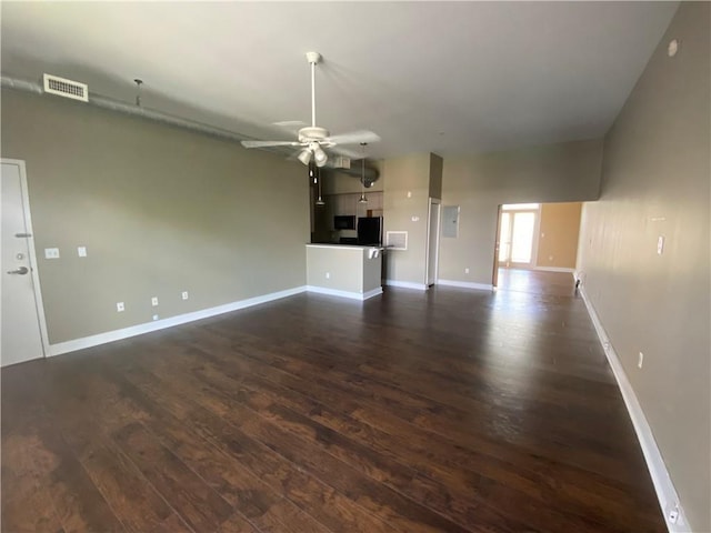 unfurnished living room with ceiling fan and dark hardwood / wood-style floors