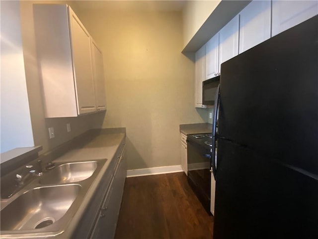 kitchen with sink, white cabinets, black appliances, and dark hardwood / wood-style flooring