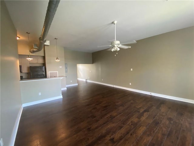 unfurnished living room with dark hardwood / wood-style floors and ceiling fan