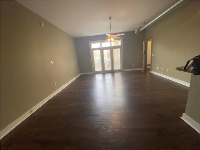 empty room featuring ceiling fan and dark hardwood / wood-style flooring