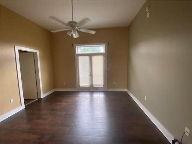 spare room with dark wood-type flooring, ceiling fan, and french doors