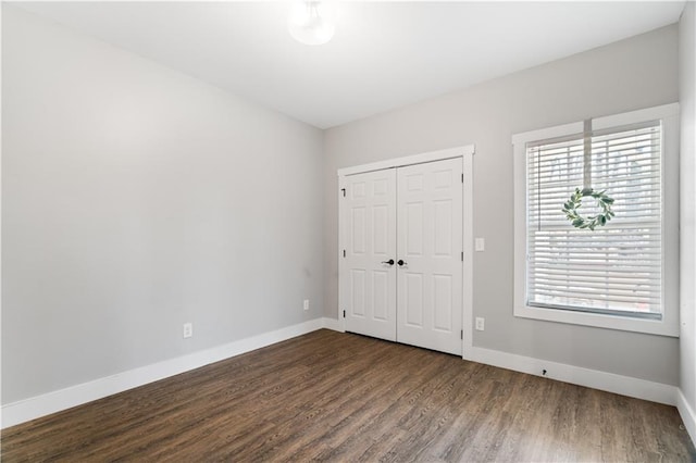 4286 Pool Rd, Winston, GA 30187 - unfurnished bedroom with dark wood-style flooring, baseboards, multiple windows, and a closet